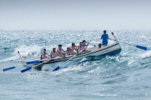 a raft boat with full of paddlers. Leadership example